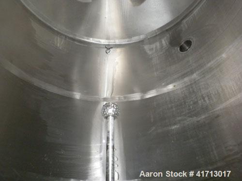 Used Filpaco Industries Tank, Approximate 6,000 Gallon, 304 Stainless Steel, Vertical.  Approximate 114" diameter x 132" straight side, slight cone top, slight dish bottom.  Top openings:  20" manway...
