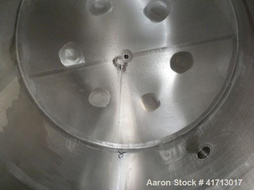 Used Filpaco Industries Tank, Approximate 6,000 Gallon, 304 Stainless Steel, Vertical.  Approximate 114" diameter x 132" straight side, slight cone top, slight dish bottom.  Top openings:  20" manway...