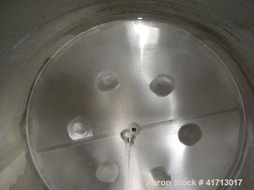 Used Filpaco Industries Tank, Approximate 6,000 Gallon, 304 Stainless Steel, Vertical.  Approximate 114" diameter x 132" straight side, slight cone top, slight dish bottom.  Top openings:  20" manway...