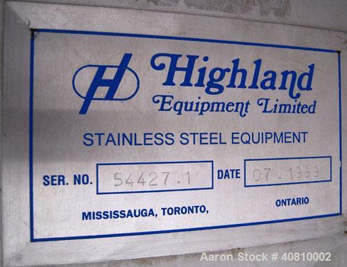 Used Highland Equipment Limited Tank, 11,887 Gallon, 304 Stainless Steel, Vertical.  132" diameter x 180" straight side, coned top and bottom.  Fixed stainless steel agitator bridge with a top enteri...
