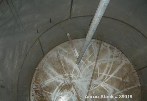 USED: Industrial Marine Inc tank, 6000 gallon, 304 stainless steel, vertical. Approximately 114" diameter x 153" straight side. Slight cone top, flat bottom. Openings: top (2) 2", 3", 10", 24" manway...