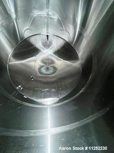 Used JV Northwest 10,000 Gallon Stainless Steel Tank with cone bottom. Vessel measures 12' diameter x 11-1/2 straight side with cone bottom leading to 4" diameter center bottom outlet with manual val...