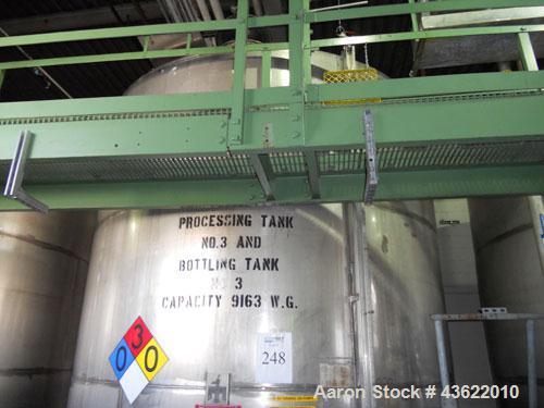 Used Krenz Approximately 8,500 Gallon Stainless Steel Storage Tank. Approximately 11' diameter x 12' straight side. Flat bottom and slight cone top. Various top openings including a 17"manway with co...