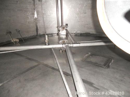 Used Krenz Approximately 8,500 Gallon Stainless Steel Storage Tank. Approximately 11' diameter x 12' straight side. Flat bottom and slight cone top. Various top openings including a 17"manway with co...