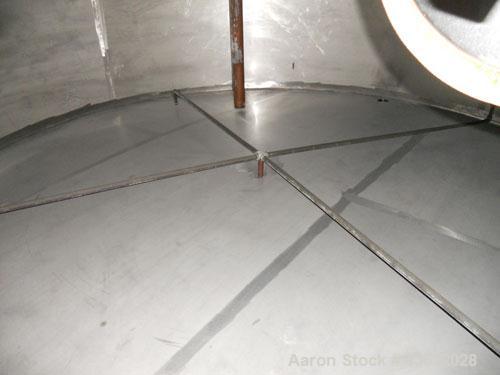 Used Krenz Approximately 7,800 Gallon Stainless Steel Storage Tank. Approximately 11' diameter x 11' straight side. Flat bottom and slight cone top. Various top openings including a 17"manway with co...