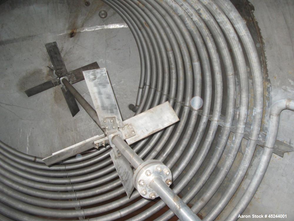 Used Master Craft, 10,000 gallons vertical T304 stainless steel tank, heated with internal pipe coil. Tank is rated for 15 psi at 250 degree F. internal. Has bank of full coil, approximately 10 turns...