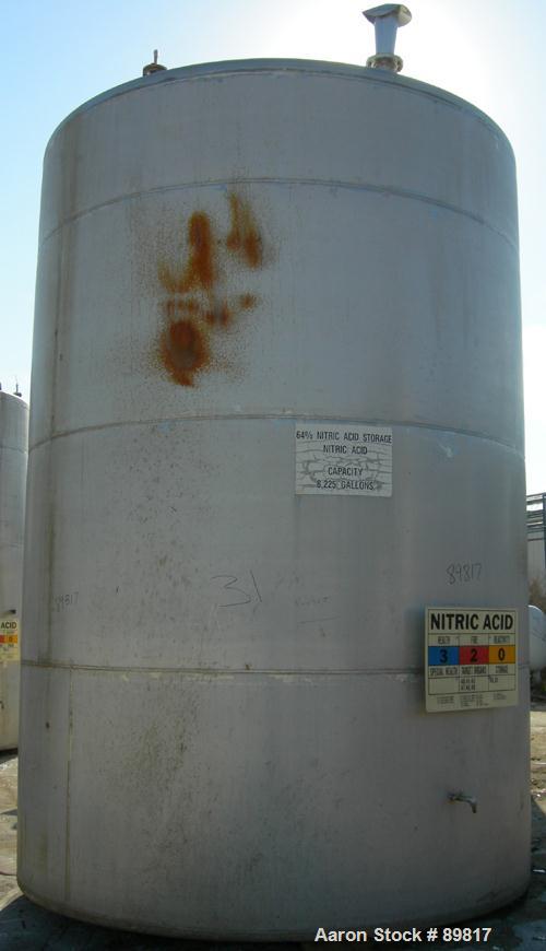 USED: Metal Equipment tank, approximately 6,760 gallon, stainless steel. Approximate 9' diameter x 14' straight side. Misc top openings. 2" end bottom outlet. Flat bottom and dish top.