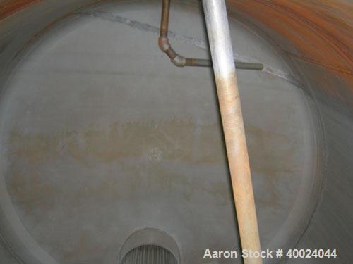 Used Tank, 6000 Gallon, 317 Stainless Steel, Horizontal. Approximately 9' diameter x 12' long, dished ends. Top entering Lightnin agitator, model 118-REC-3.2, ratio 17.40 to 1, output 100/50 rpm. 2" ...