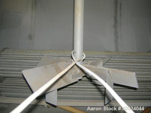 Used Tank, 6000 Gallon, 317 Stainless Steel, Horizontal. Approximately 9' diameter x 12' long, dished ends. Top entering Lightnin agitator, model 118-REC-3.2, ratio 17.40 to 1, output 100/50 rpm. 2" ...