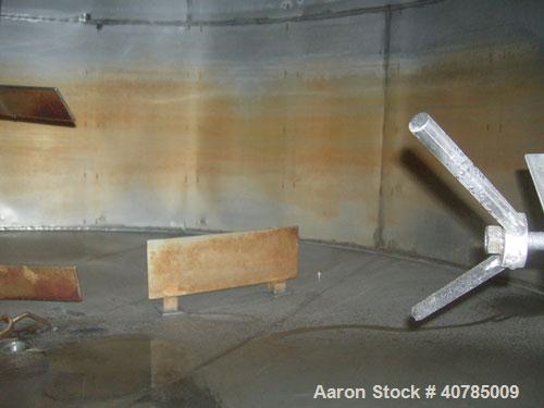 Used Tank, 6,000 Gallon, 304 Stainless Steel, Vertical. 144" diameter x 84" straight side. Flat top, slight coned bottom. Top carbon steel agitator bridge with an approximately 2" diameter bottom sup...