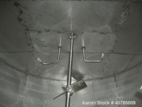 Used Tank, 6,000 Gallon, 304 Stainless Steel, Vertical. 144" diameter x 84" straight side. Flat top, slight coned bottom. Top carbon steel agitator bridge with an approximately 2" diameter bottom sup...