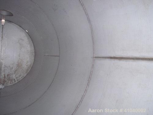 Used Tank, 6,000 Gallon, 304 Stainless Steel, Vertical.  Approximate 96" diameter x 192" straight side. Dish top, flat bottom.  Openings: top 20" bolt on manway with cover with 8" hinged door, 1/2" N...