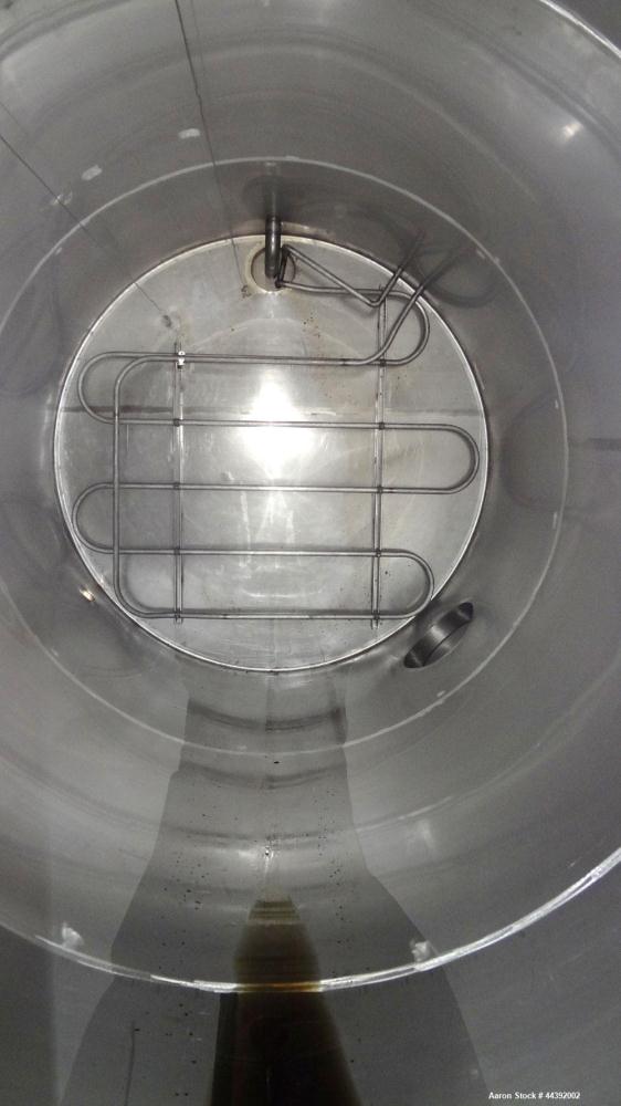 Used Tank, 5200 Gallon, 304 Stainless Steel, Vertical. Approximately 96" diameter x 170" straight side, flat top and bottom. Approximately 2" bottom head internal pipe coil. Openings: top 42" x 5" wi...