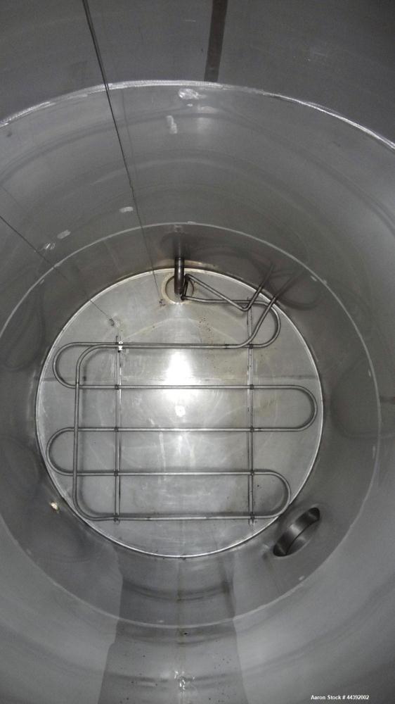 Used Tank, 5200 Gallon, 304 Stainless Steel, Vertical. Approximately 96" diameter x 170" straight side, flat top and bottom. Approximately 2" bottom head internal pipe coil. Openings: top 42" x 5" wi...