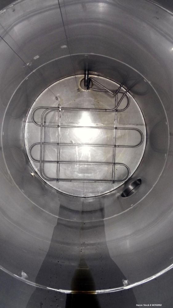 Used Tank, 5200 Gallon, 304 Stainless Steel, Vertical. Approximately 96" diameter x 170" straight side, flat top and bottom. Approximately 2" bottom head internal pipe coil. Openings: top 42" x 5" wi...