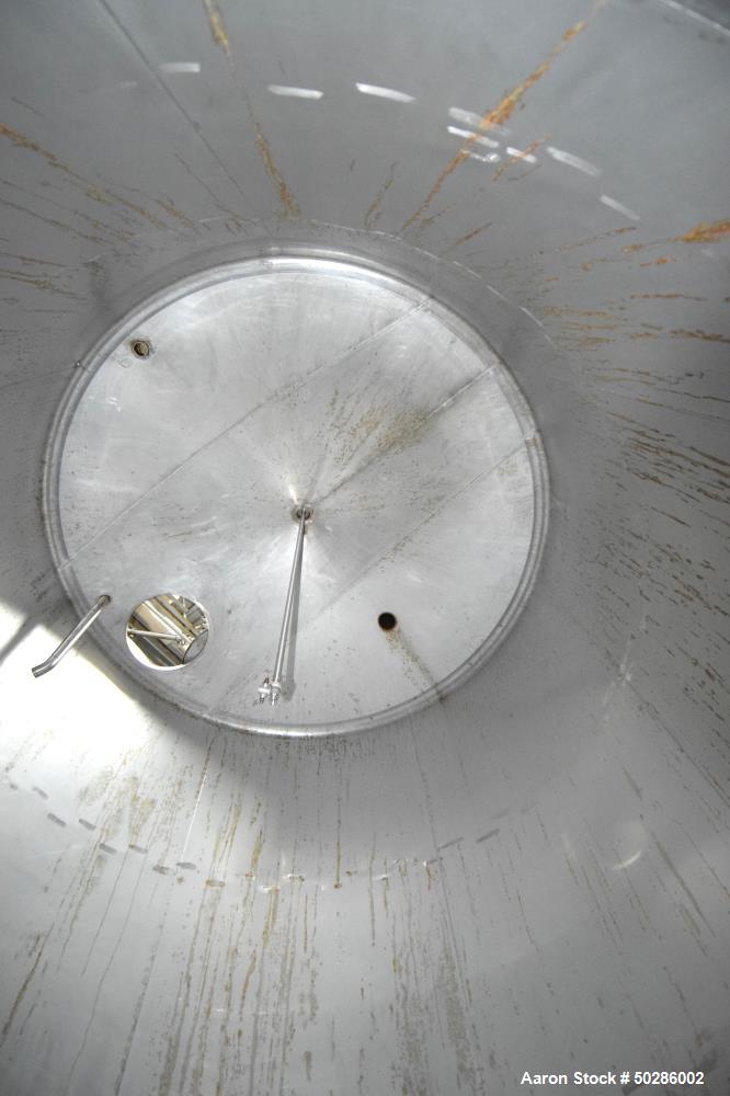 Used Perry Products Tank, 5,200 Gallon, Model VCWX, 304 Stainless Steel, Vertical. Approximate 106" diameter x 132" straight side, coned top & bottom. (1) Spray nozzle. Openings top 2", 3", (2) 4", 1...