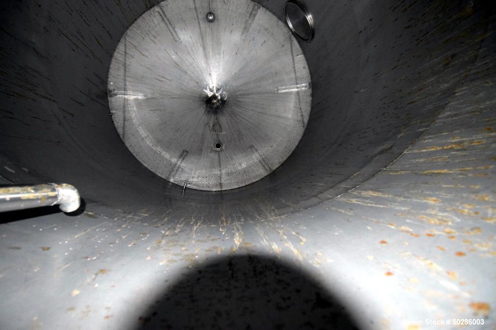 Used Perry Products Tank, 5,200 Gallon, 304 Stainless Steel, Vertical. Approximate 106" diameter x 132" straight side, coned top & bottom. (1) Spray nozzle. Openings top 2", 3", (2) 4", 18" man way w...
