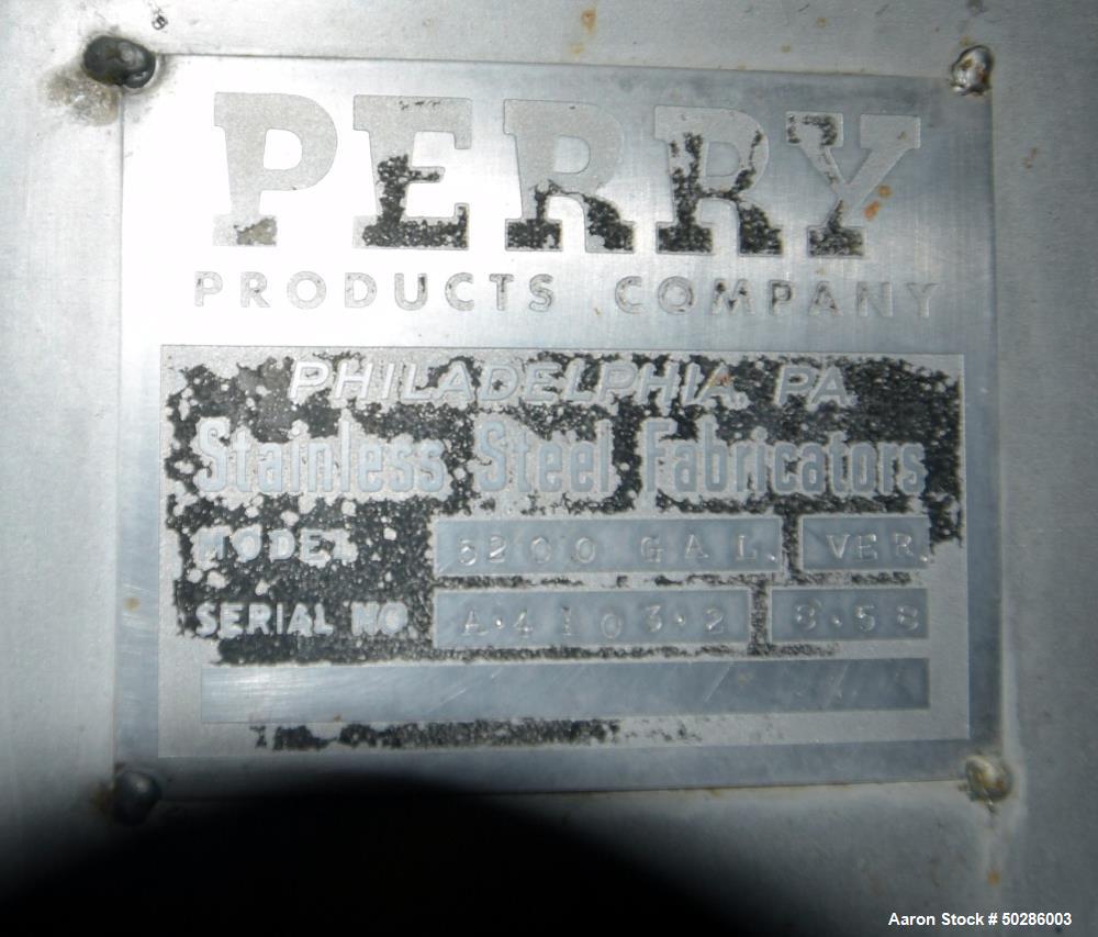 Used Perry Products Tank, 5,200 Gallon, 304 Stainless Steel, Vertical. Approximate 106" diameter x 132" straight side, coned top & bottom. (1) Spray nozzle. Openings top 2", 3", (2) 4", 18" man way w...
