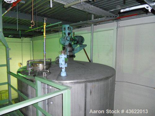 Used Saracco Tank & Mfg Approximately 5,200 Gallon Stainless Steel Storage Tank. Approximately 9' diameter x 11' straight side. Flat bottom and slight cone top. Various top openings including a 17" m...