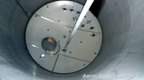 Used Stainless Metals Inc Tank, 8800 Gallon, 304L Stainless Steel, Vertical. Approximate 120" diameter x 180" straight side, dished top, flat bottom. Openings top (12) 3", 24" man way with cover, sid...