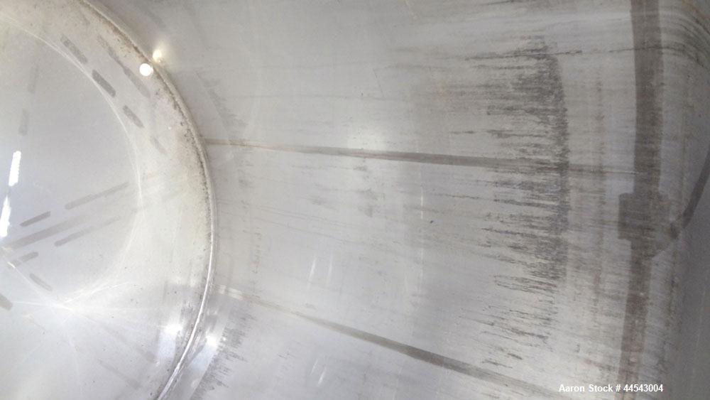 Used Walker Stainless Tank, 5000 Gallon, Model 9560, 304 Stainless Steel, Vertical. Approximate 120” diameter x 104” straight side, dished top, sloped bottom. Openings top (2) 3” NPT, 18” man way wit...
