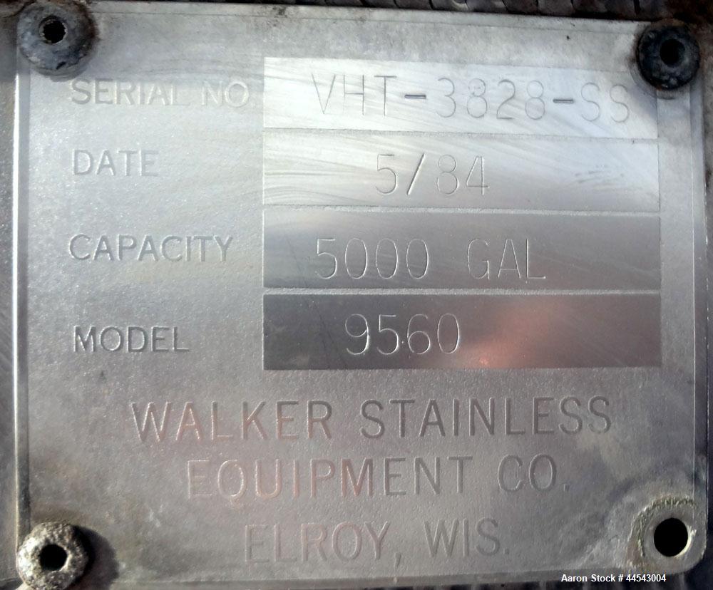 Used Walker Stainless Tank, 5000 Gallon, Model 9560, 304 Stainless Steel, Vertical. Approximate 120” diameter x 104” straight side, dished top, sloped bottom. Openings top (2) 3” NPT, 18” man way wit...