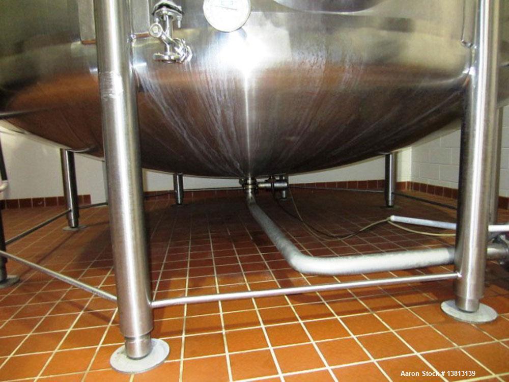 Used Walker Stainless 10,000 Gallon top agitated stainless steel single wall mixing tank.  Bottom side manway, dish top and bottom, (2) sets of mixing blades, dual CIP spray ball, thermometer, 3" tri...