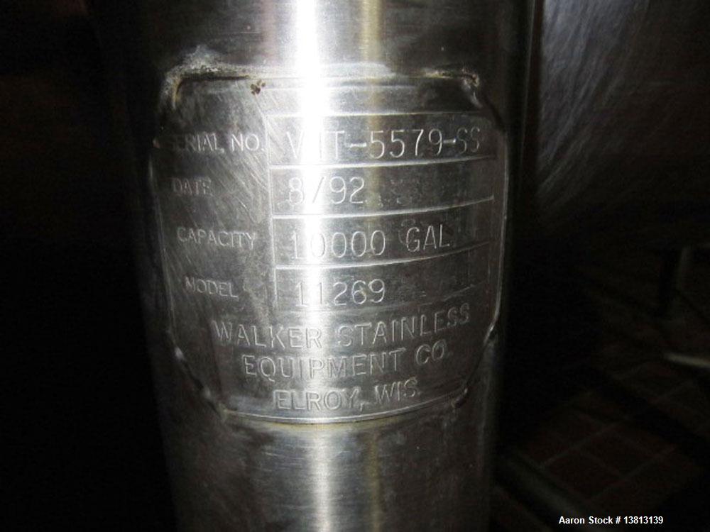 Used Walker Stainless 10,000 Gallon top agitated stainless steel single wall mixing tank.  Bottom side manway, dish top and bottom, (2) sets of mixing blades, dual CIP spray ball, thermometer, 3" tri...