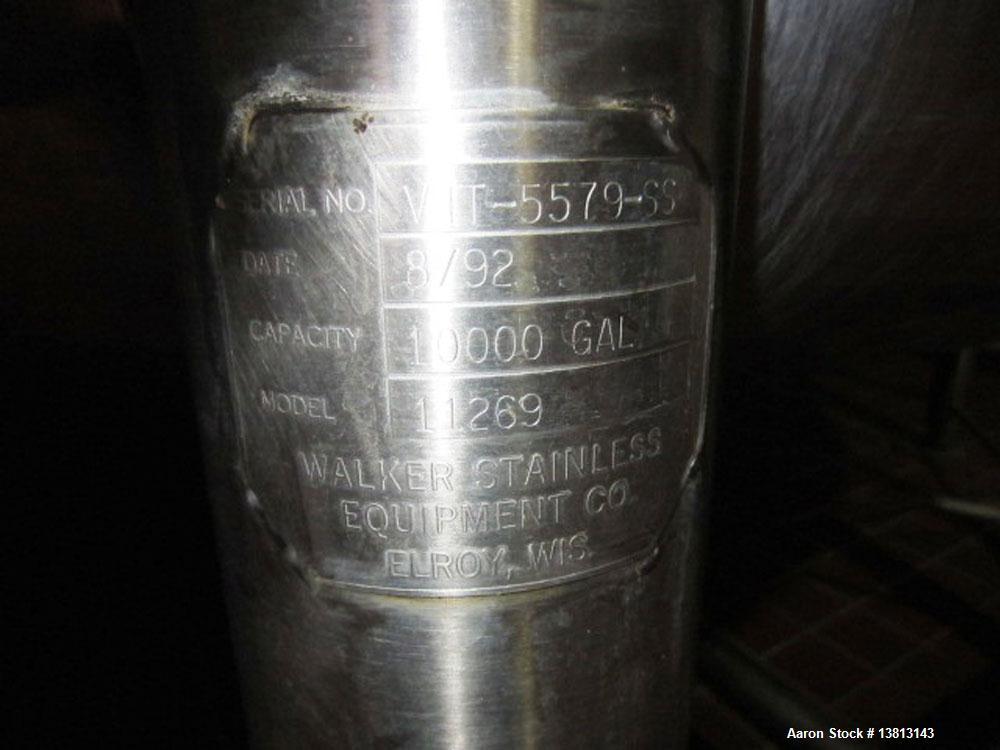 Used Walker Stainless 10,000 Gallon top agitated type 304 stainless steel single wall mixing tank. Bottom side manway, dish top and bottom, (2) sets of mixing blades, dual CIP spray ball, thermometer...