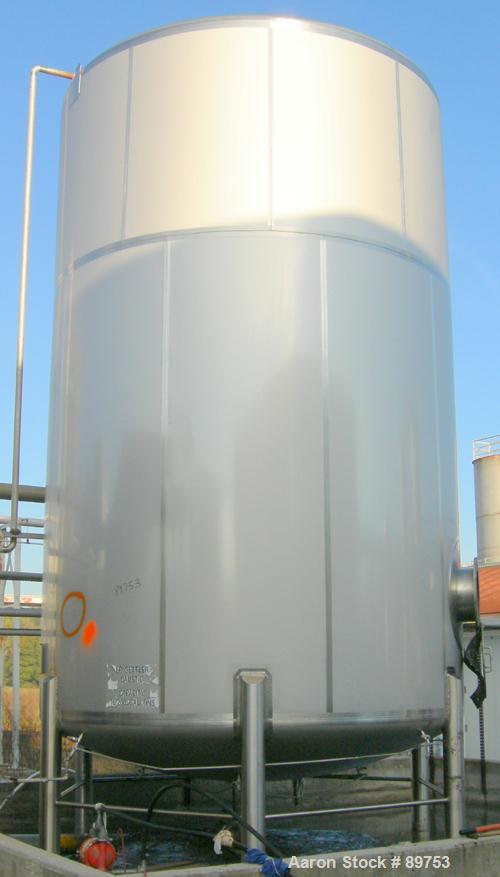 USED: Walker 16,200 gallon, type 304L stainless steel storage tank. Vertical, dished heads. Approximately 12' diameter x 18' straight side. Misc top openings. Side openings include an 18" manway with...