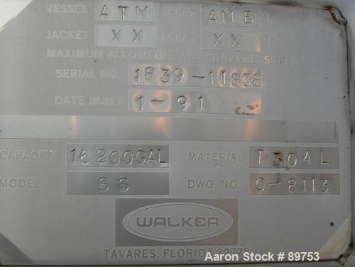 USED: Walker 16,200 gallon, type 304L stainless steel storage tank. Vertical, dished heads. Approximately 12' diameter x 18' straight side. Misc top openings. Side openings include an 18" manway with...