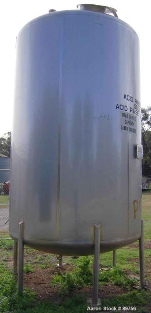 USED: Walker 5,000 gallon, type 304L stainless steel, storage tank. Vertical, dished heads. Approximate 8' diameter x 12' straight side. Misc top and side flanged openings. Bottom has a 2" center out...
