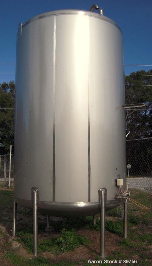 USED: Walker 5,000 gallon, type 304L stainless steel, storage tank. Vertical, dished heads. Approximate 8' diameter x 12' straight side. Misc top and side flanged openings. Bottom has a 2" center out...