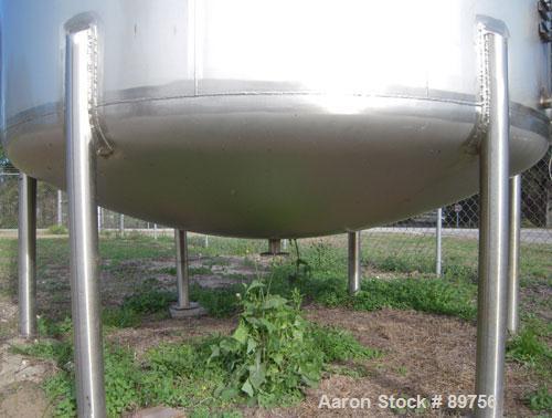 USED: Walker 5,000 gallon, type 304L stainless steel, storage tank. Vertical, dished heads. Approximate 8' diameter x 12' straight side. Misc top and side flanged openings. Bottom has a 2" center out...