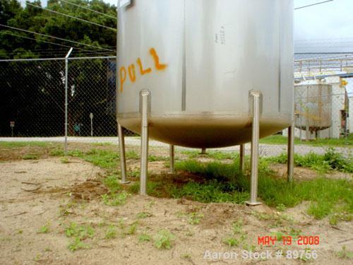 USED: Walker 5,000 gallon, type 304L stainless steel, storage tank. Vertical, dished heads. Approximate 8' diameter x 12' straight side. Misc top and side flanged openings. Bottom has a 2" center out...