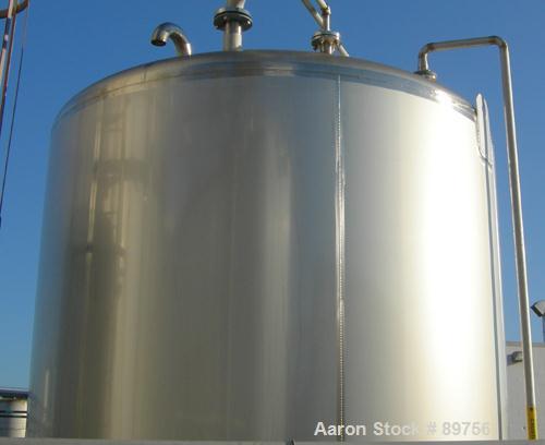 USED: Walker 5,000 gallon, type 304L stainless steel, storage tank. Vertical, dished heads. Approximate 8' diameter x 12' straight side. Misc top and side flanged openings. Bottom has a 2" center out...