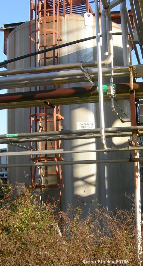 USED: Walker 16,000 gallon, type 316L stainless steel, storage tank. Vertical, dished heads. Approximate 12' diameter x 18' straight side. Misc top and side flanged openings. Side openings include an...