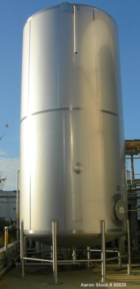 USED: Walker 21,000 gallon, type 304L stainless steel, storage tank. Vertical, dished heads. Approximate 12' diameter x 24' straight side. Top openings include an 18" manway with bolt-on cover, 2" fl...