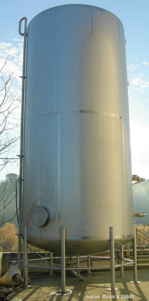 USED: Walker 21,000 gallon, type 304L stainless steel, storage tank. Vertical, dished heads. Approximate 12' diameter x 24' straight side. Top openings include an 18" manway with bolt-on cover, 2" fl...