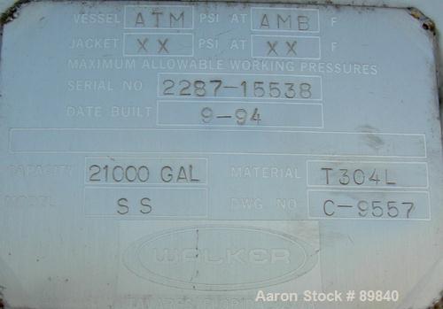 USED: Walker 21,000 gallon, type 304L stainless steel, storage tank. Vertical, dished heads. Approximate 12' diameter x 24' straight side. Top openings include an 18" manway with bolt-on cover, 2" fl...