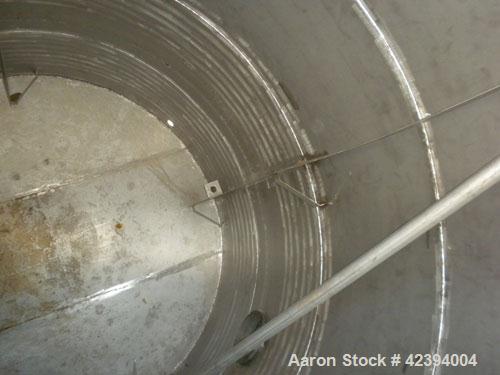 Used Wolfe Mechanical and Equipment Tank, 14,000 gallon, 304L stainless steel, vertical. Approximately 144" diameter x 192" straight side, dished top, sloped bottom. Internal rated 5 psi at 150 deg F...