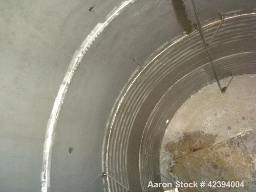 Used Wolfe Mechanical and Equipment Tank, 14,000 gallon, 304L stainless steel, vertical. Approximately 144" diameter x 192" straight side, dished top, sloped bottom. Internal rated 5 psi at 150 deg F...