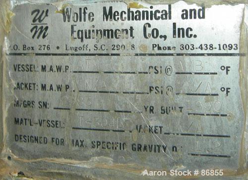 Used Wolfe Mechanical and Equipment Tank, 7,660 Gallon, 304L Stainless Steel, Vertical. Approximate 120" diameter x 156" straight side. Dish top, flat bottom. Openings: top (3) 3", 1-1/2"; side 3/4",...