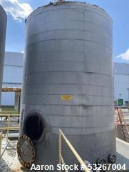 approximately 9000 gallon stainless steel vertical storage tank.