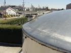 Used 6000 Gallon 304 Stainless Steel Vertical Tank with Dished Heads on Six Legs. Tank is 120
