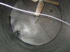 Used Approximate 10,000 gallon vertical 304 stainless steel tank. 11' Diameter x 15' straight side. With flat top and slope bottom heads.