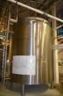 Used- 6,000 Gallon (Approximately) Stainless Steel Vertical Aseptic Product Tank. Dome top, flat bottom off center. Top moun...