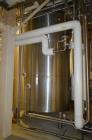 Used- 6,000 Gallon (Approximately) Stainless Steel Vertical Aseptic Product Tank. Dome top, flat bottom off center. Top moun...