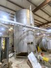 Used-Stainless Steel Tank.  Approximately 7,000 gallon; 9' diameter x 15' straight side; Vetical; Slight coned top and botto...