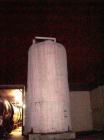 Used 20,000 Gallon Stainless Steel Storage Tank. Flat top and bottom, side discharge. Approximately 12' in diameter x 25' overall height. Exterior has spray foam insulation.
